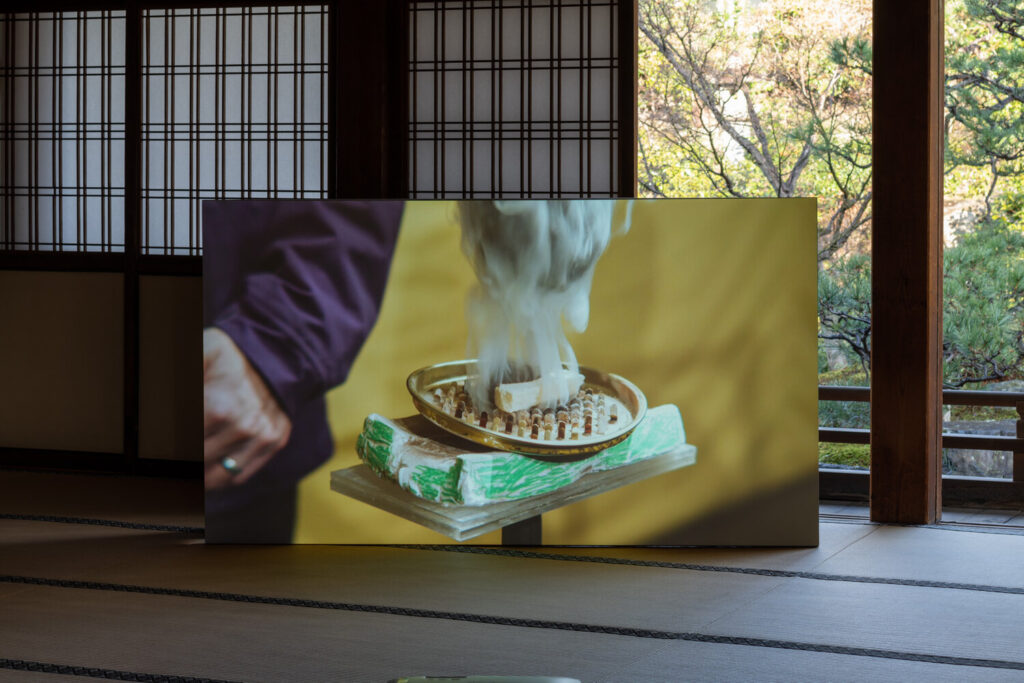 A large rectangular object with a picture of a person holding a bowl with a fire.